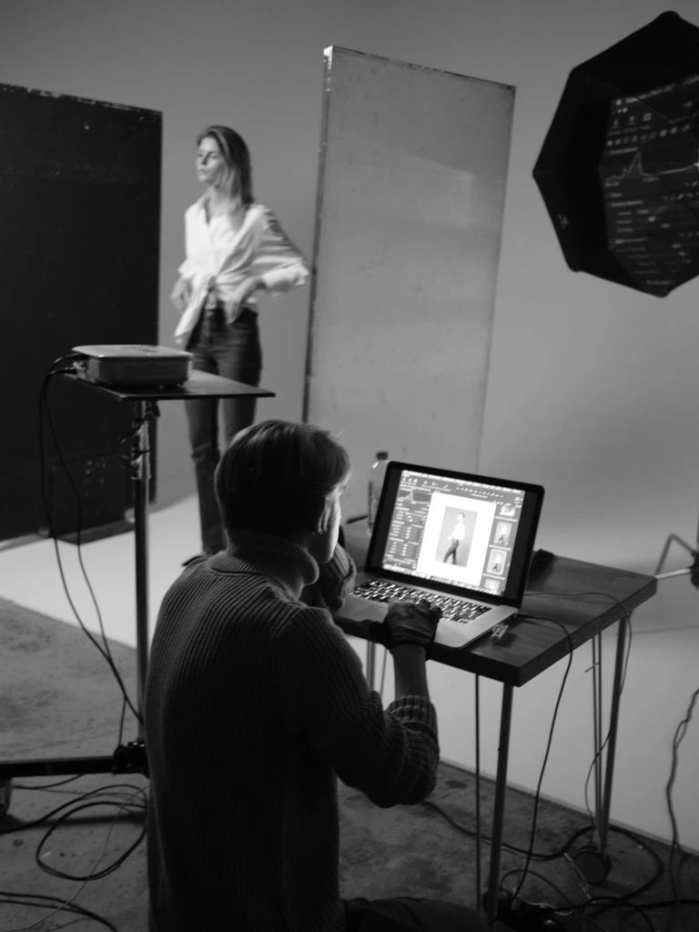 Coach reviewing athlete training data on a monitor in a gym office